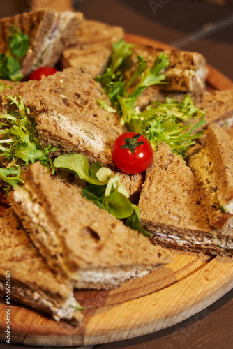 black bread sandwiches on a plate. light snacks. sandwiches for breakfast