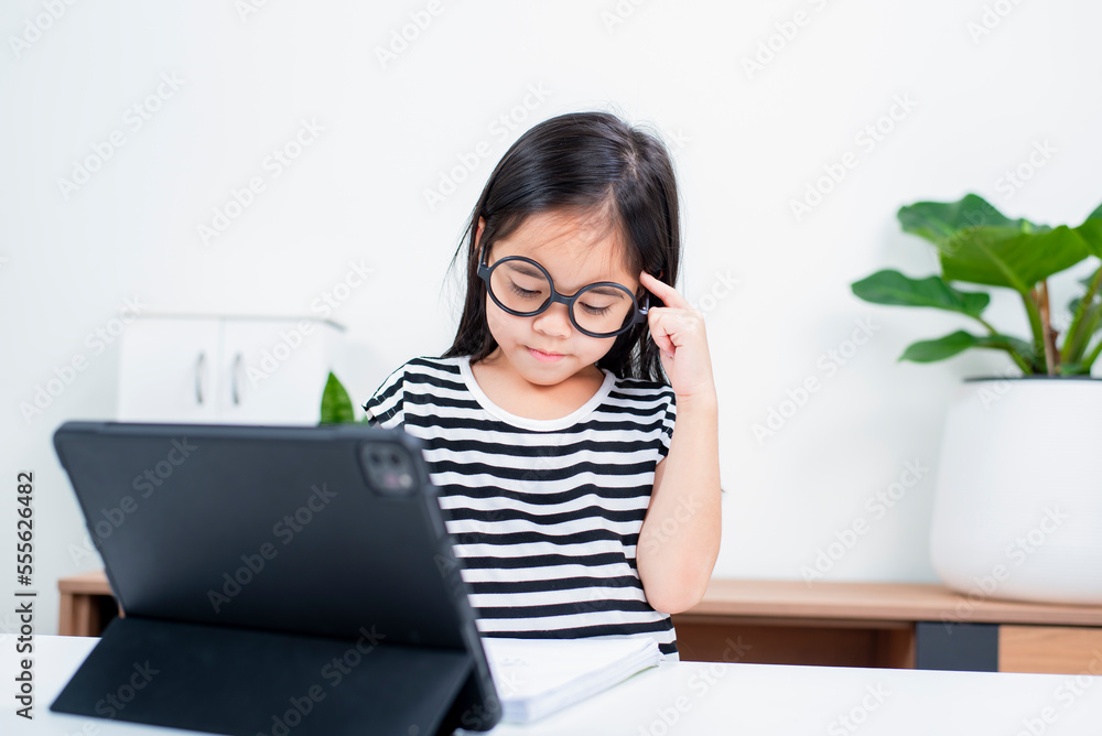 Asian child girl student wow excited on video call learning to studying online class or person learn from home school with tablet Asian child girl student wow excited on video call learning to studying online class or person learn from home school with tablet