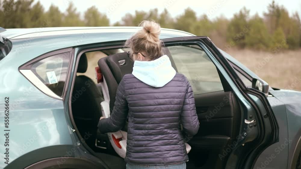 mother using baby car seat to transport children mother using baby car seat to transport children