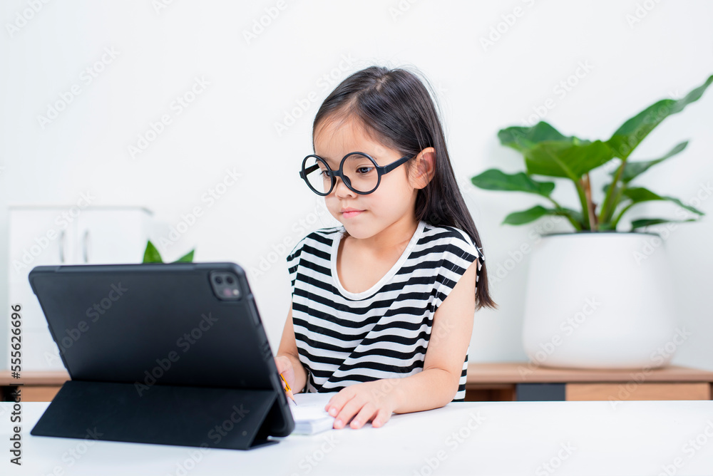 Asian child girl student wow excited on video call learning to studying online class or person learn from home school with tablet Asian child girl student wow excited on video call learning to studying online class or person learn from home school with tablet