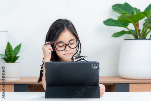 Asian child girl student wow excited on video call learning to studying online class or person learn from home school with tablet