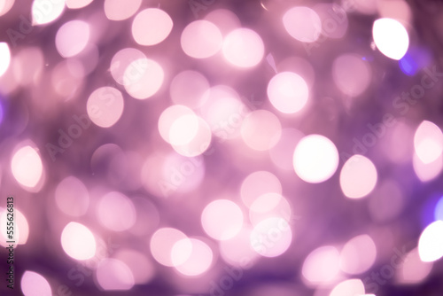 Bright bokeh of lights, blurred night background. New Year celebration.
