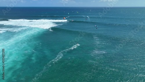 An athlete on a wave board rides the big ocean waves of a living reef in the Indian Ocean. One of the best surf spots on the planet. Sports hobby