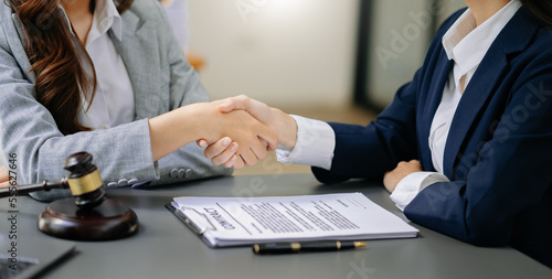 Consultation between a male lawyer and business customer, handshake after good deal agreement, Law and Legal concept.