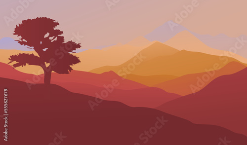 Silhouette of a tree on a background of mountains. Sunrise over the mountain range. Perfect for website, social media, desktop, wallpapers, postcards.