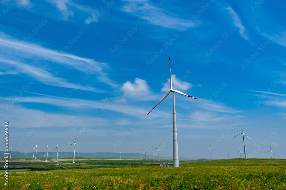 huge wind generators in nature. Green clean energy. Conservation of natural resources thanks to windmills huge wind generators in nature. Green clean energy. Conservation of natural resources thanks to windmills