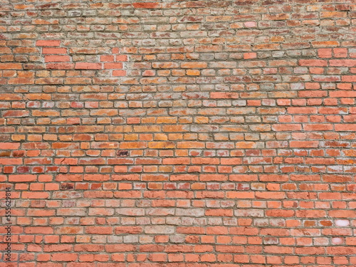 An old red brick wall. Historical horizontal brickwork for wallpaper and surface design. Brick pattern. 