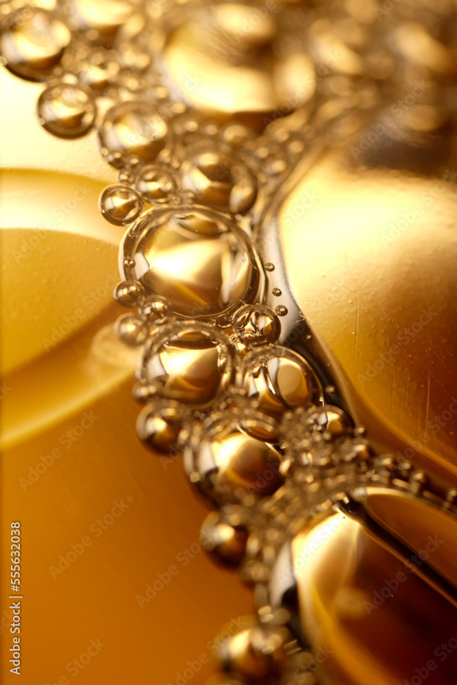 Macro shot of golden liquid bubbles Macro shot of golden liquid bubbles