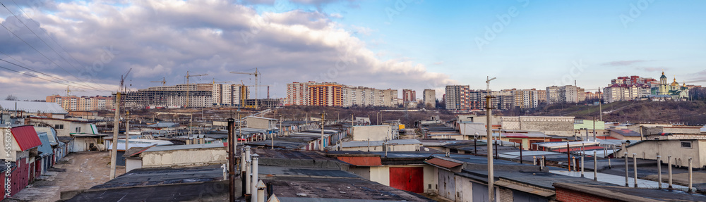 Panorama of new buildings in an ordinary Ukrainian city. Garage cooperative in the foreground