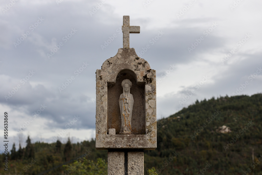 Weathered Stone Wayside Shrine with Cross and Statue in Rural Hills
Weathered Stone Wayside Shrine with Cross and Statue in Rural Hills