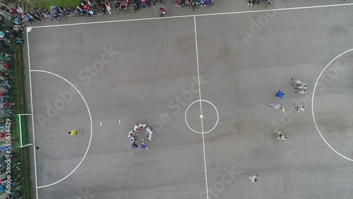 Canvas Print top view drone flying above amateur soccer game match