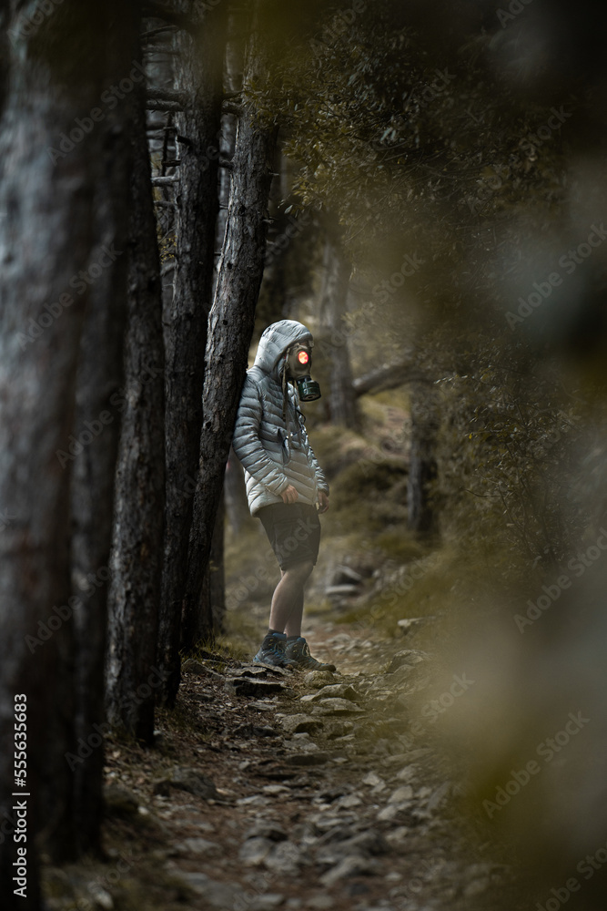 Obraz premium Post Apocalyptic environmental portrait with a gas mask in a dark forest in the evening