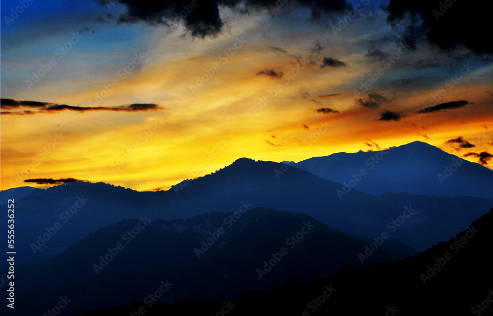 Fiery sunset over the mountains of Carnia, Friuli Venezia Giulia, Italy