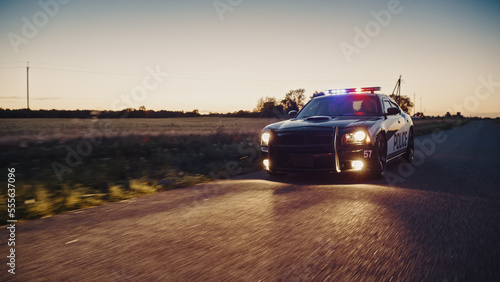 Highway Traffic Patrol Car In Pursuit of Criminal Vehicle. Police Officers in Squad Car Chase Suspect on Industrial Area Road. Criminal Crashes Boxes. Cinematic Atmospheric High Speed Action Scene © Gorodenkoff
