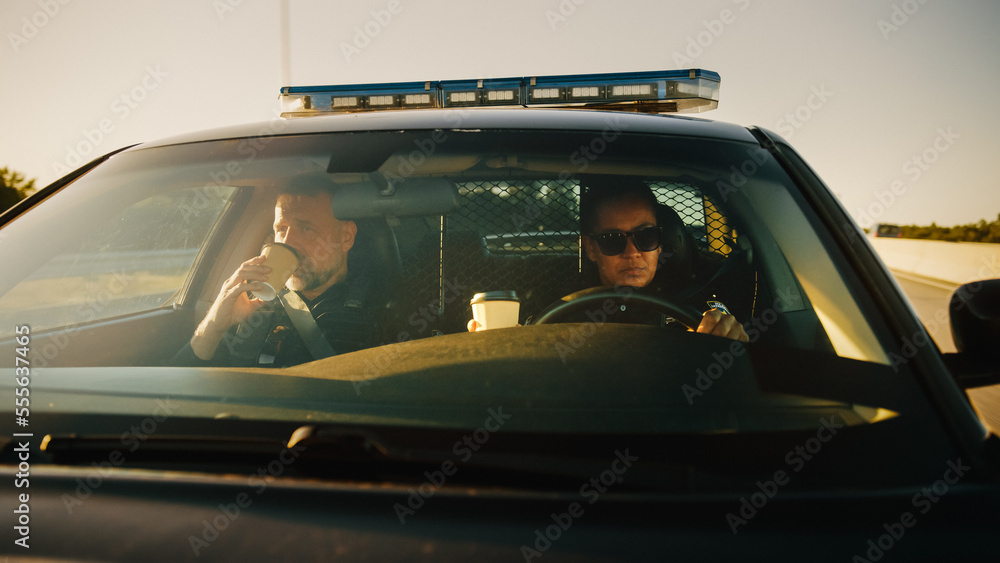 Point of View: Two Police Officers Driving Traffic Patrol Car, Drink Coffee, Chat, Joke Around, Ready to Fight Crime. Police Patroling, Officers of the Law Maintain Public Order, Safety, Investigation