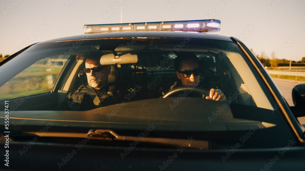 Point of View: Two Police Officers Driving Traffic Patrol Car, Ready to Fight Crime. Squad Car Police Patroling, Crusing, Officers of the Law Maintain Public Order, Safety