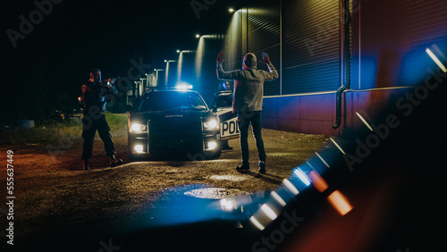 Obraz na plátně Two Police Officers Arrest Suspect, Order Him to Get on the Knees and Hands Back, Cuff Felon