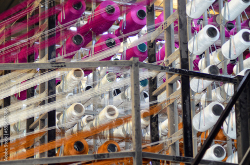 White, Pink and Orange Reel Spool Sewing Threads at Textile Weaving Mill