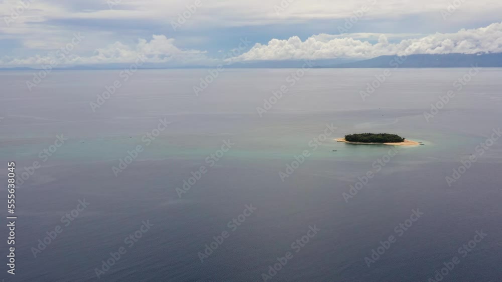 Tropical island with sandy beach in the blue sea with coral reef, top view. Rosa island, Philippines. Tropical island with sandy beach in the blue sea with coral reef, top view. Rosa island, Philippines.