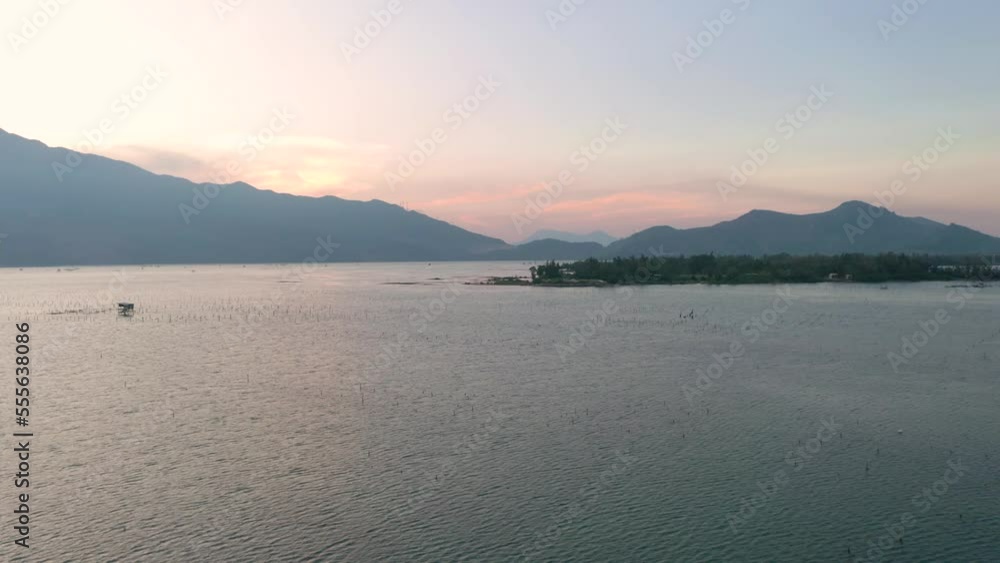 Dreamy aerial drone of picturesque and peaceful asian landscape with lake, mountains and local fishing village in Lang Co, Vietnam. Dreamy aerial drone of picturesque and peaceful asian landscape with lake, mountains and local fishing village in Lang Co, Vietnam.