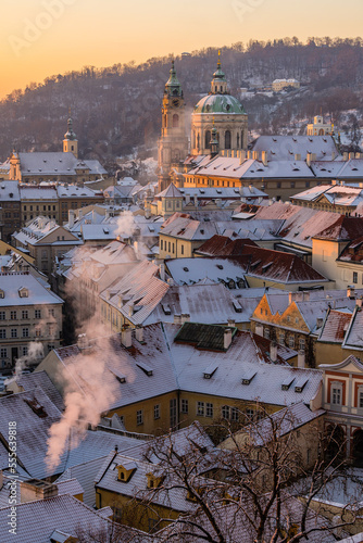Obraz na płótnie Mala Strana and St. Nicholas Church in old town of Prague covered in snow in the winter morning. w salonie