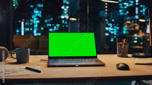Obraz na plátně Laptop Standing on a Desk with a Green Screen Chromakey Mock Up Display
