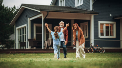 Grandfather and Grandmother are Happy to Meet Their Granddaughter in Front of their Suburbs House. Grandparents Spending the Weekend with Kids, Enjoying Family Time with Grandchild.