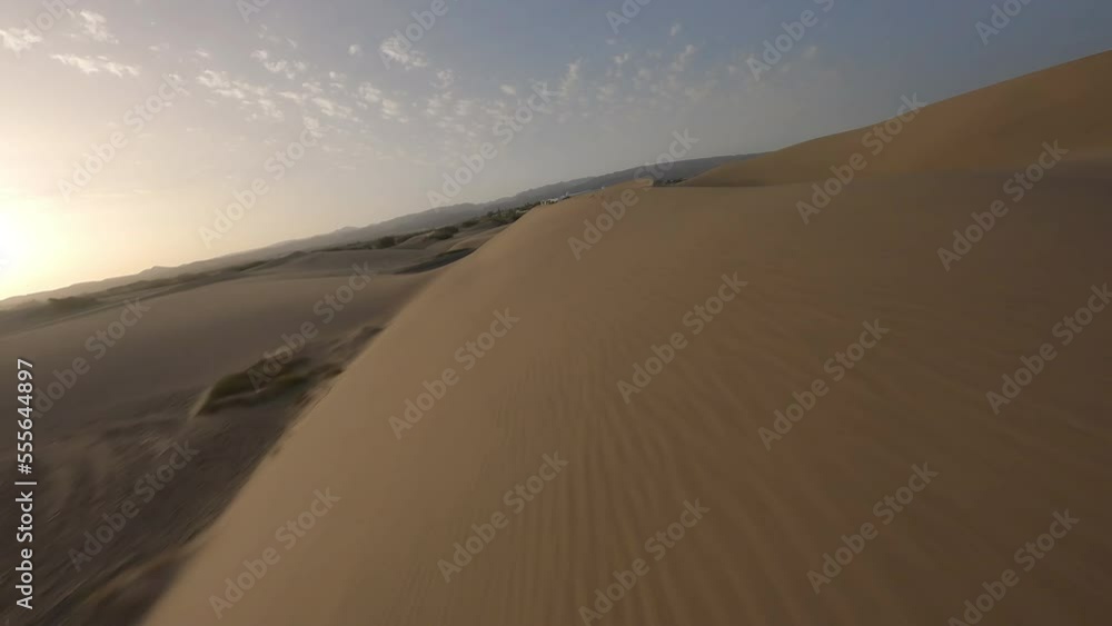 Fast FPV aerial drone flies above desert sand dunes in Desierto Maspalomas Fast FPV aerial drone flies above desert sand dunes in Desierto Maspalomas