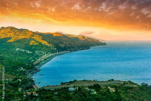 travel landscape scenic picture of beautiful highland mountain town in sunrise or sunset with sea shore on background