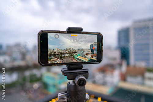 Wallpaper Mural Close-up smartphone on tripod capturing night cityscape  timelapse. Mobile photography or videography concept. Torontodigital.ca