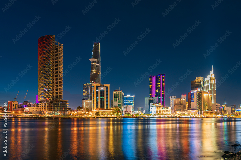 Ho Chi Minh City skyline and the Saigon River at night. Amazing colorful view of skyscraper and other modern buildings. Travel concept