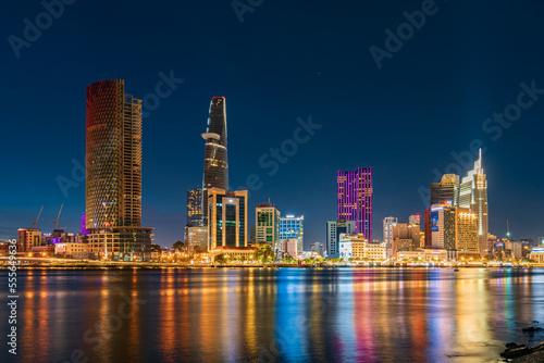 Ho Chi Minh City skyline and the Saigon River at night. Amazing colorful view of skyscraper and other modern buildings. Travel concept © Quang Ho