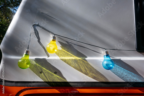 Colored light bulbs in a camper van. © karrastock