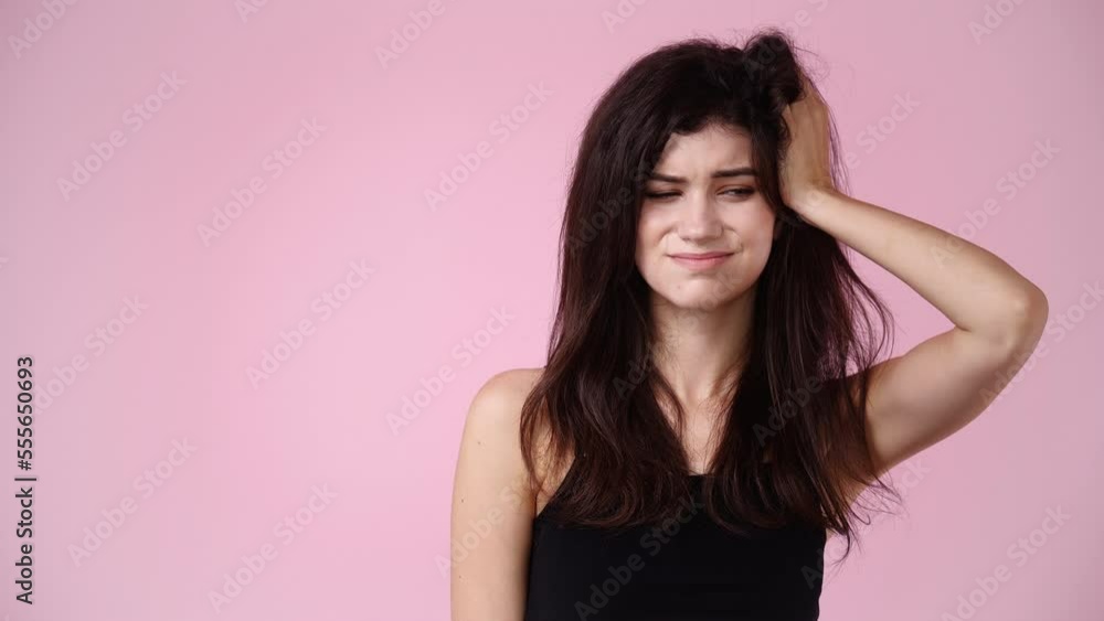 4k slow motion video of a woman thinking about something over pink background. 4k slow motion video of a woman thinking about something over pink background.