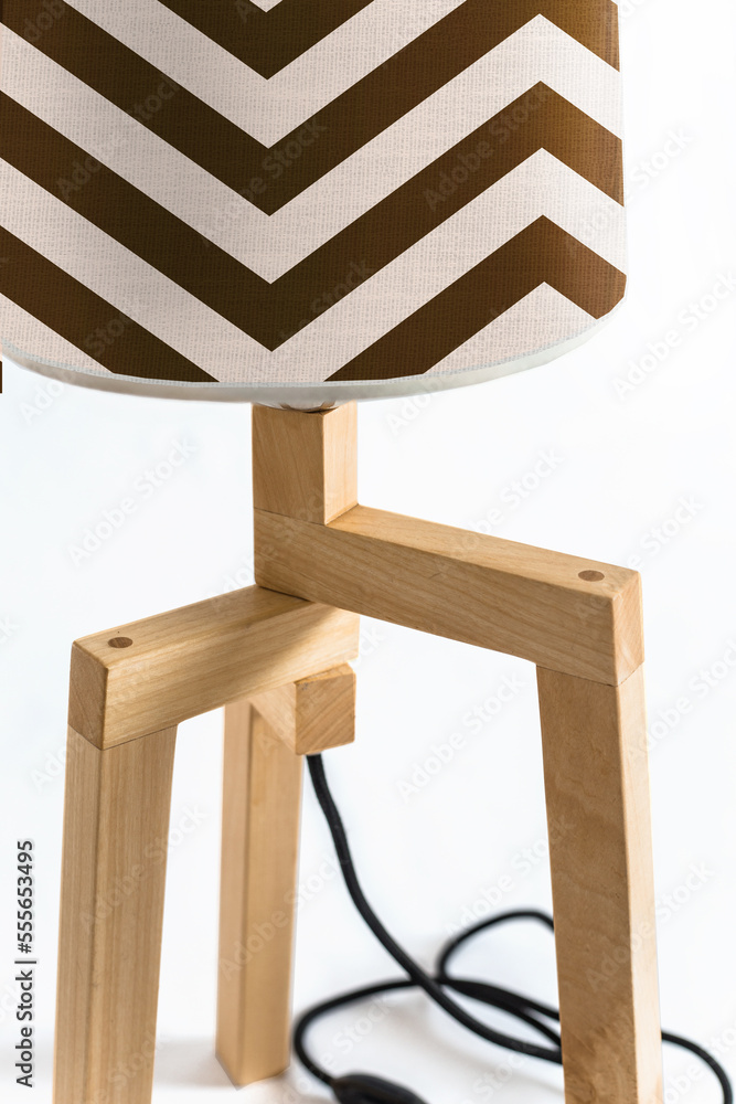 Fototapeta premium Wooden tripod lamp. Minimalist lamp and lighting design for home interior.