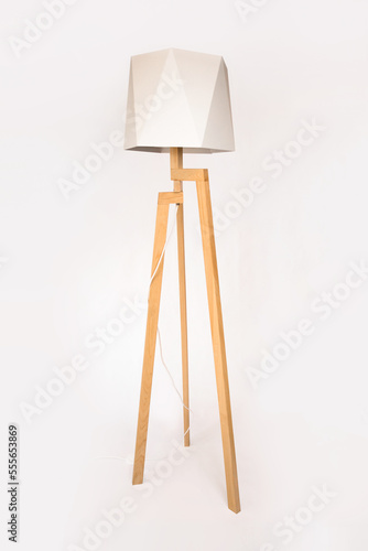 Wooden tripod lamp. Minimalist lamp and lighting design for home interior.