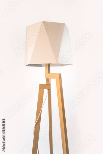 Wooden tripod lamp. Minimalist lamp and lighting design for home interior.
