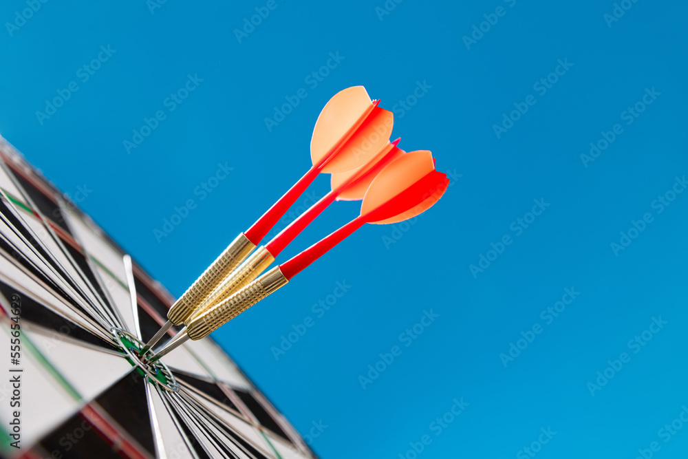 Three darts hitting on center target Three darts hitting on center target