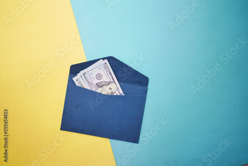 100 dollar cash in a envelope on a desk 