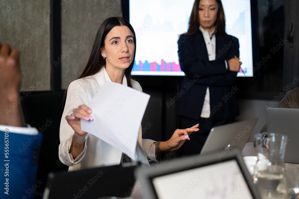 Business woman working late in office with colleagues, young female trader discussing about stock asset with teamwork Business woman working late in office with colleagues, young female trader discussing about stock asset with teamwork