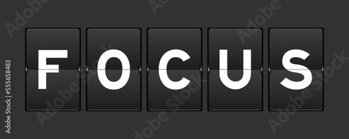 Black color analog flip board with word focus on gray background