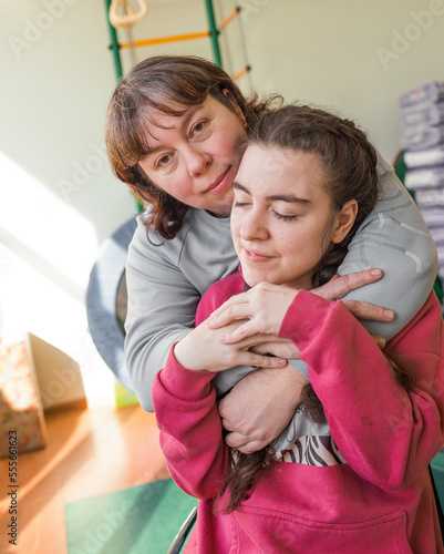 a girl diagnosed with autism with her mother in a rehabilitation center.
