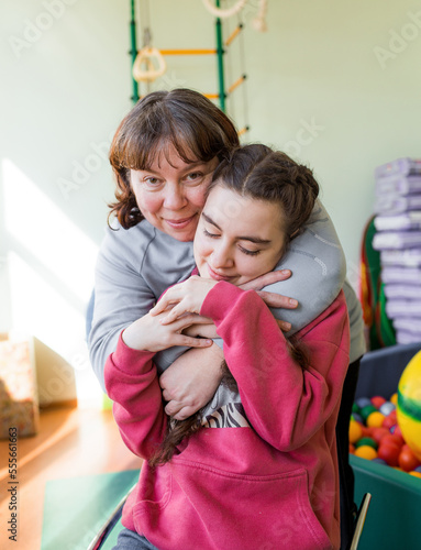 a girl diagnosed with autism with her mother in a rehabilitation center.