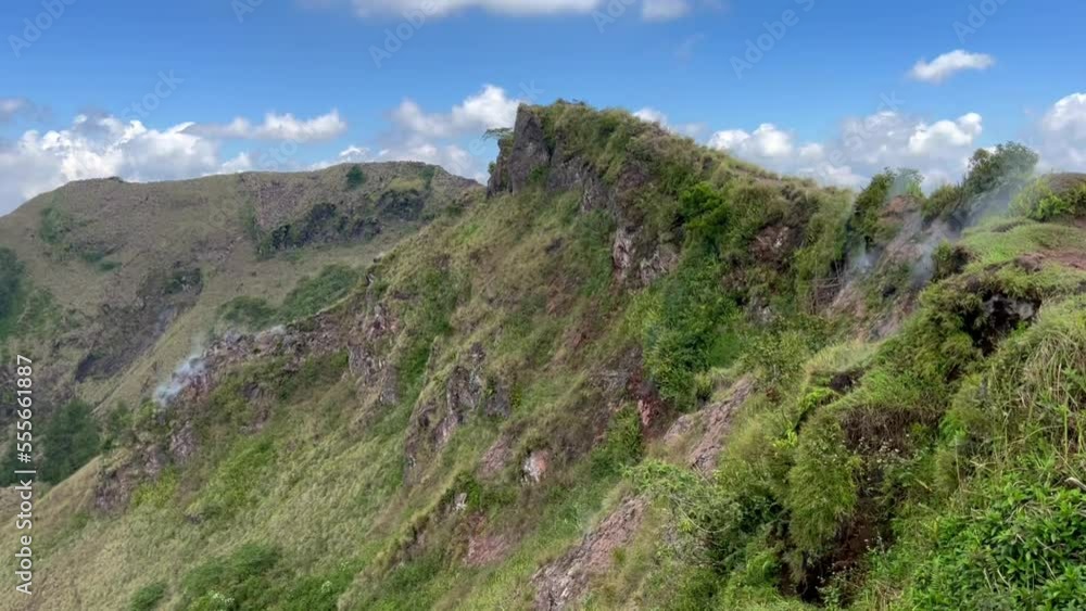 Landscape from peak of Mount Batur, an active volcano with a steam vents and lake Landscape from peak of Mount Batur, an active volcano with a steam vents and lake