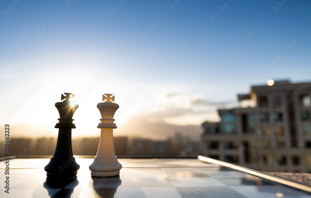 Fototapeta premium Two chess kings on city background