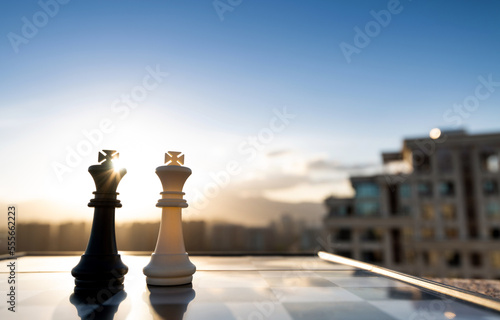 Two chess kings on city background