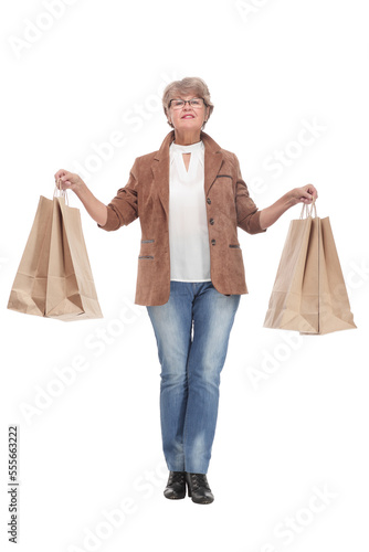 Happy senior woman with shopping bags on white background