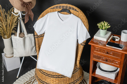 A v neck shirt hanged on to a chair with minimalist decorations