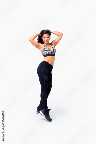 Fototapeta Naklejka Na Ścianę i Meble -  Young fitness instructor woman dancing. Latina dancing zumba. Female zumba instructor. Isolated.
