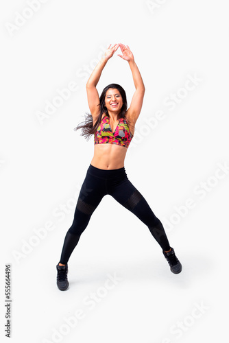 Young fitness instructor woman dancing. Latina dancing zumba. Female zumba instructor. Isolated.